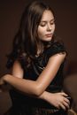 Attractive Female Model Sitting Towards Backrest in Chair