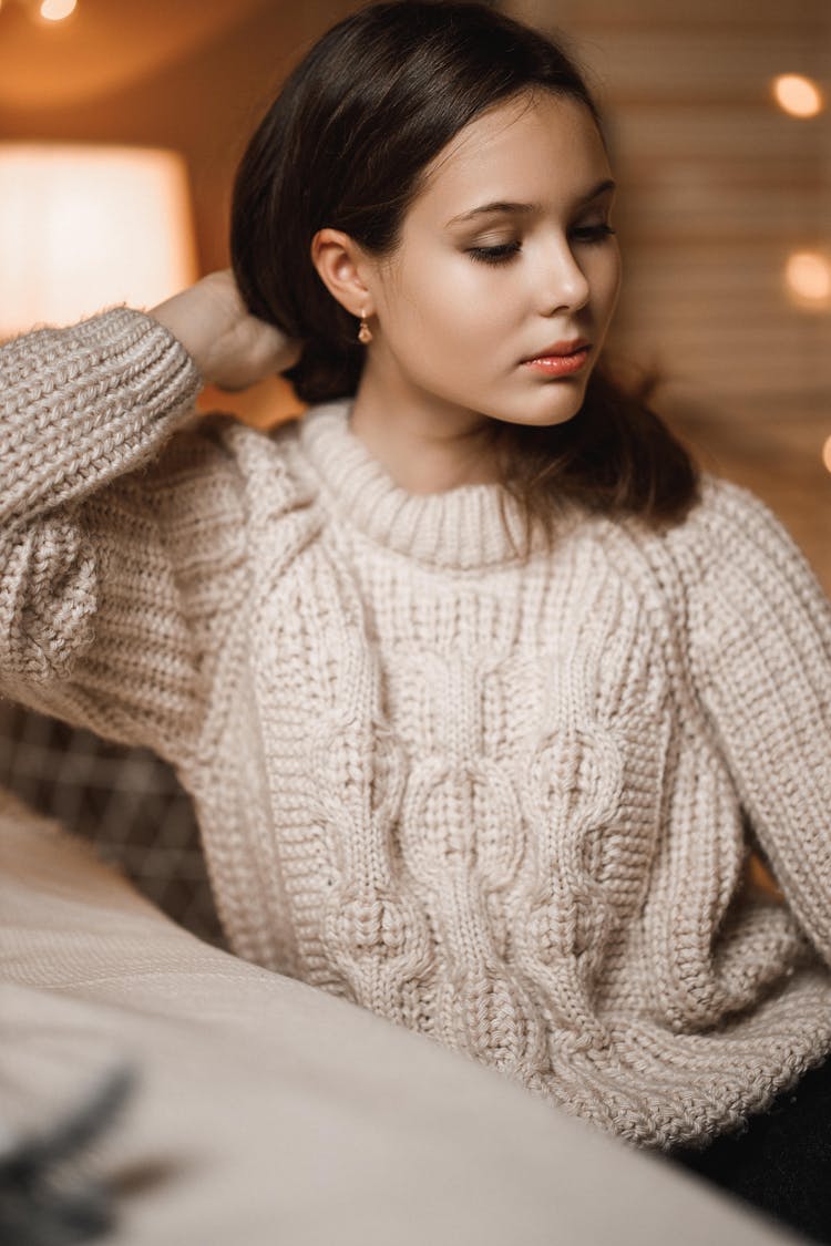 Young Woman With Brown Long Hair Wearing Knitted Pullover