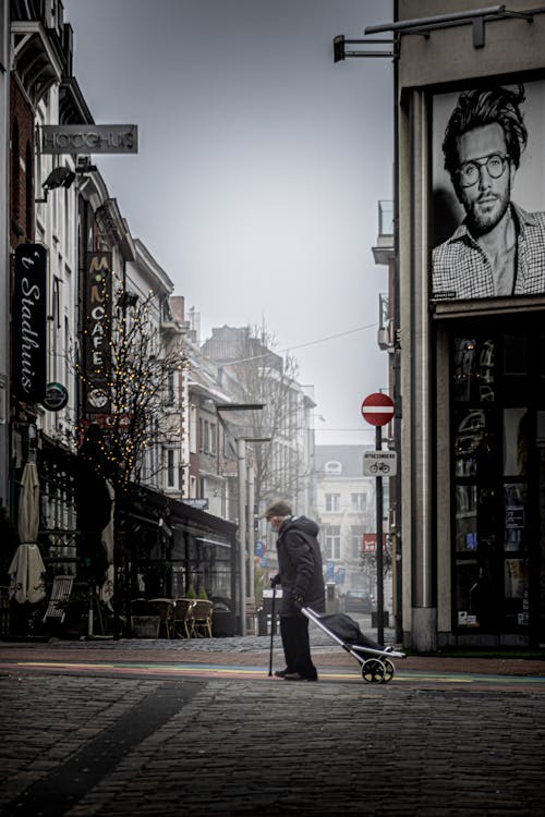 Photo of an Elderly Man Standing in a Street