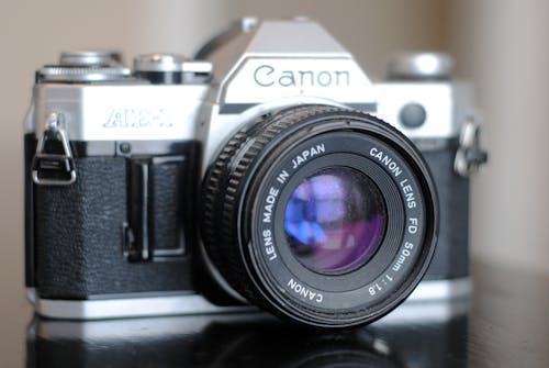 Free Black and Silver Canon Ae-1 Camera  Stock Photo