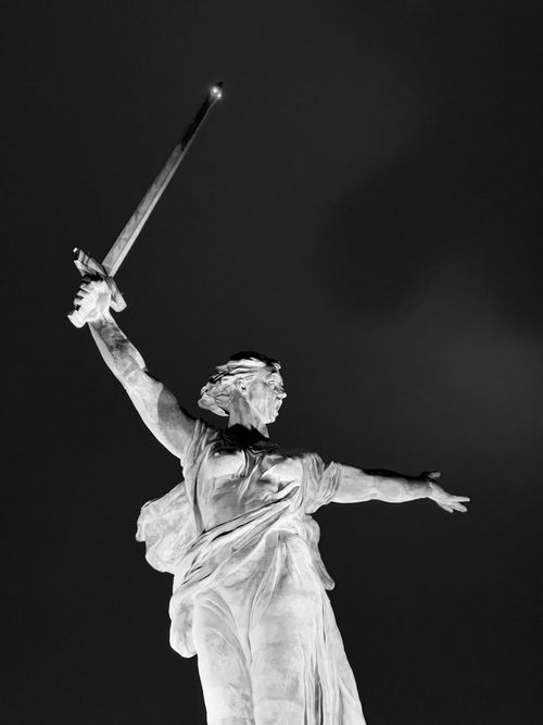 Free Black and white photo of the Motherland Calls statue in Volgograd under a dramatic night sky. Stock Photo