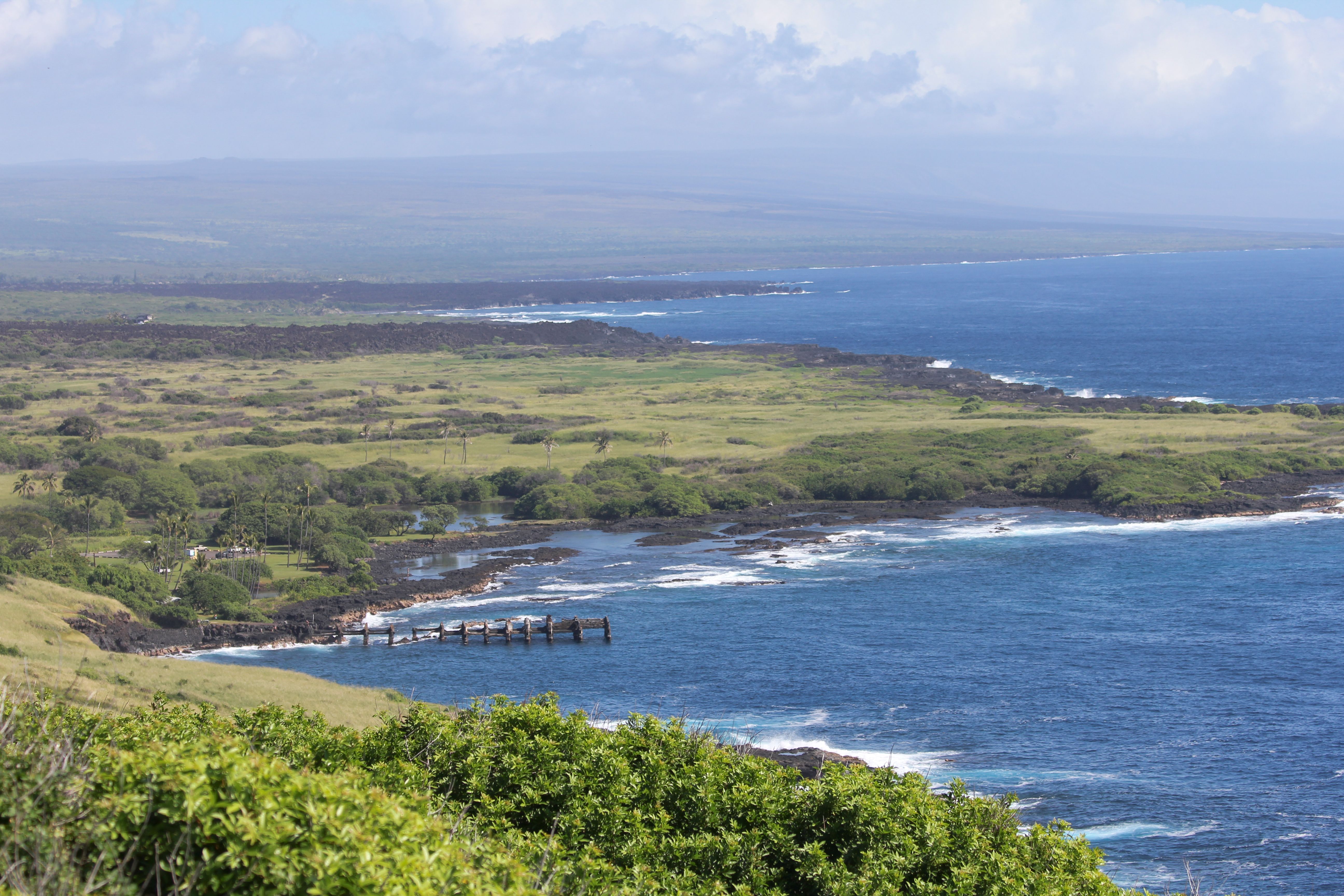 Explore the lush greens and blue waters of Whittington Beach Park, Hawaii from above.