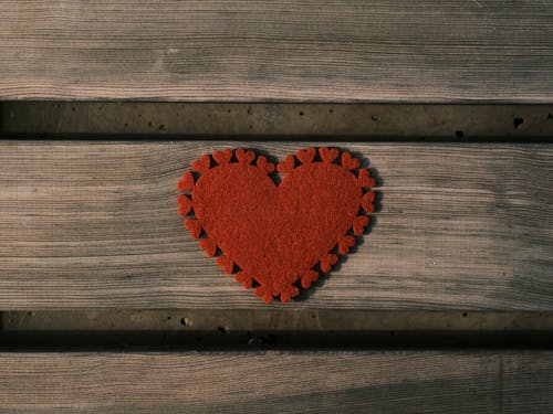 A Red Heart on Wooden Surface