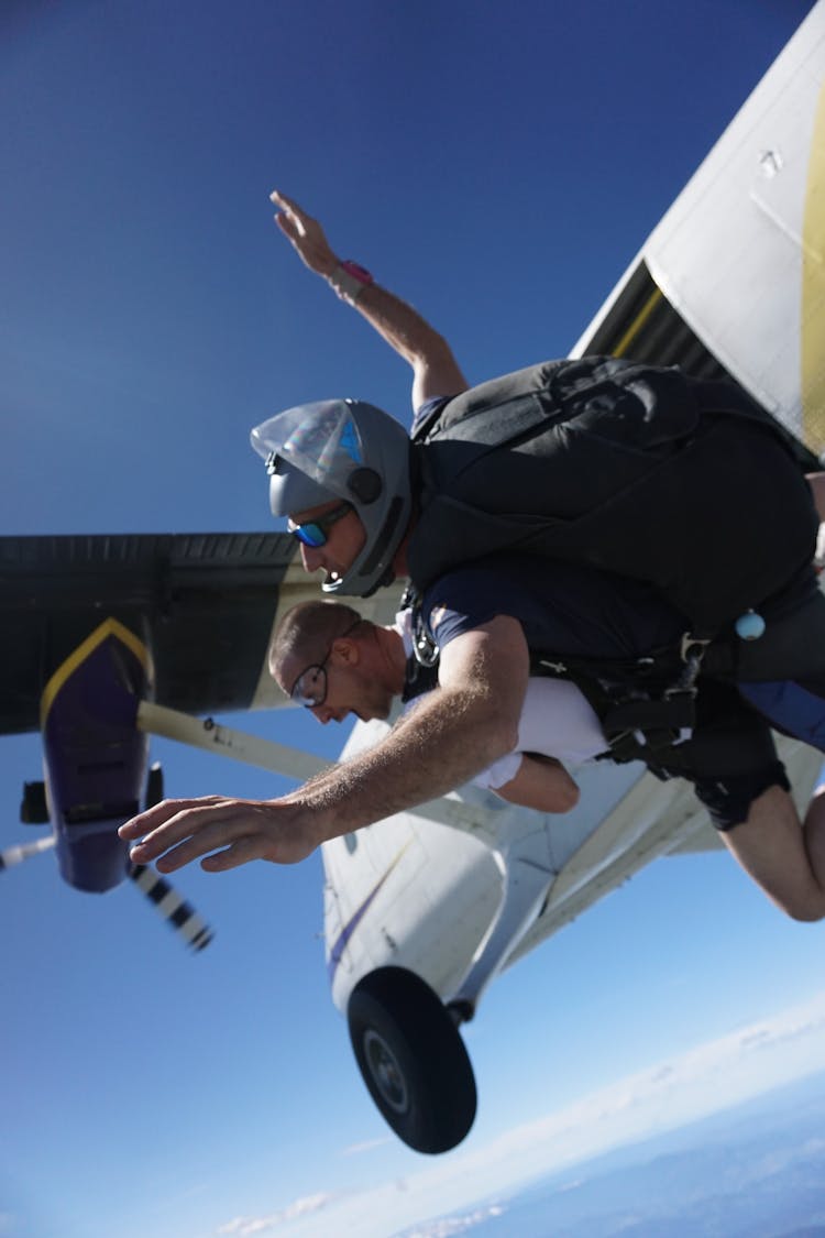 Men Skydiving Out Of Plane