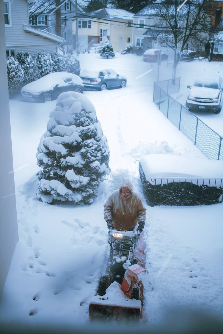 Man Plowing Snow In Yard