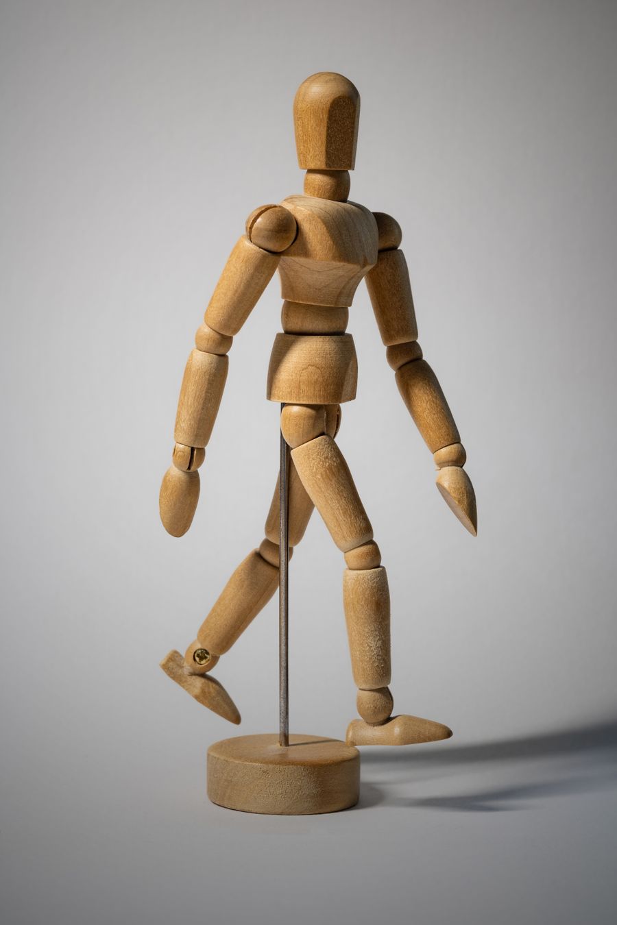 Articulated wooden artist figure in a walking stance — photo by Niklas Jeromin on Pexels