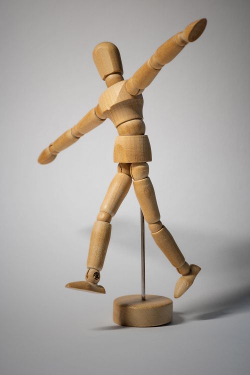 A Handmade Wooden Human Figure on Pedestal · Free Stock Photo