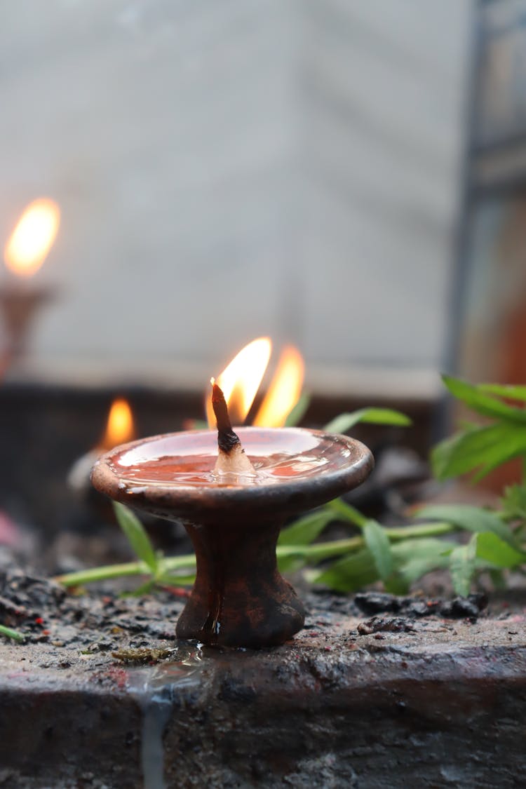 Close-Up Shot Of Terracotta Oil Lamps As Religious Offerings