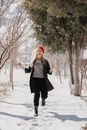 Woman in Red Beret Running Through Snow