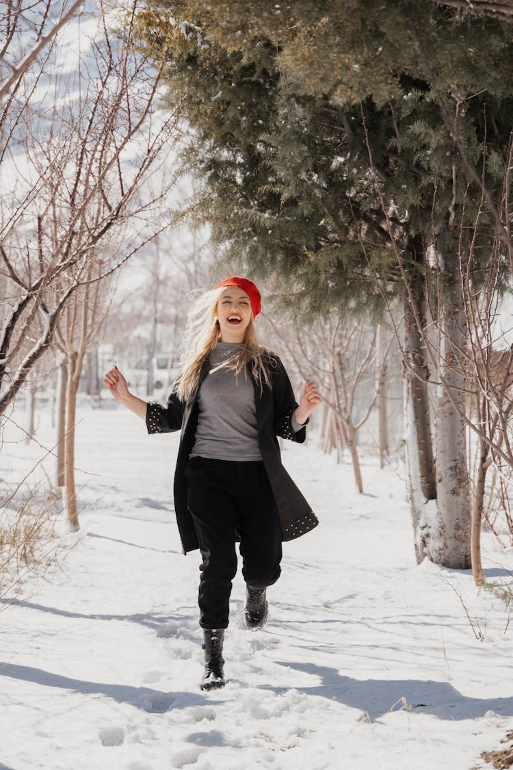 Woman In Red Beret Running Through Snow