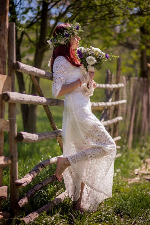 Woman In White Long-sleeved Gown Holding Flower Bouquet