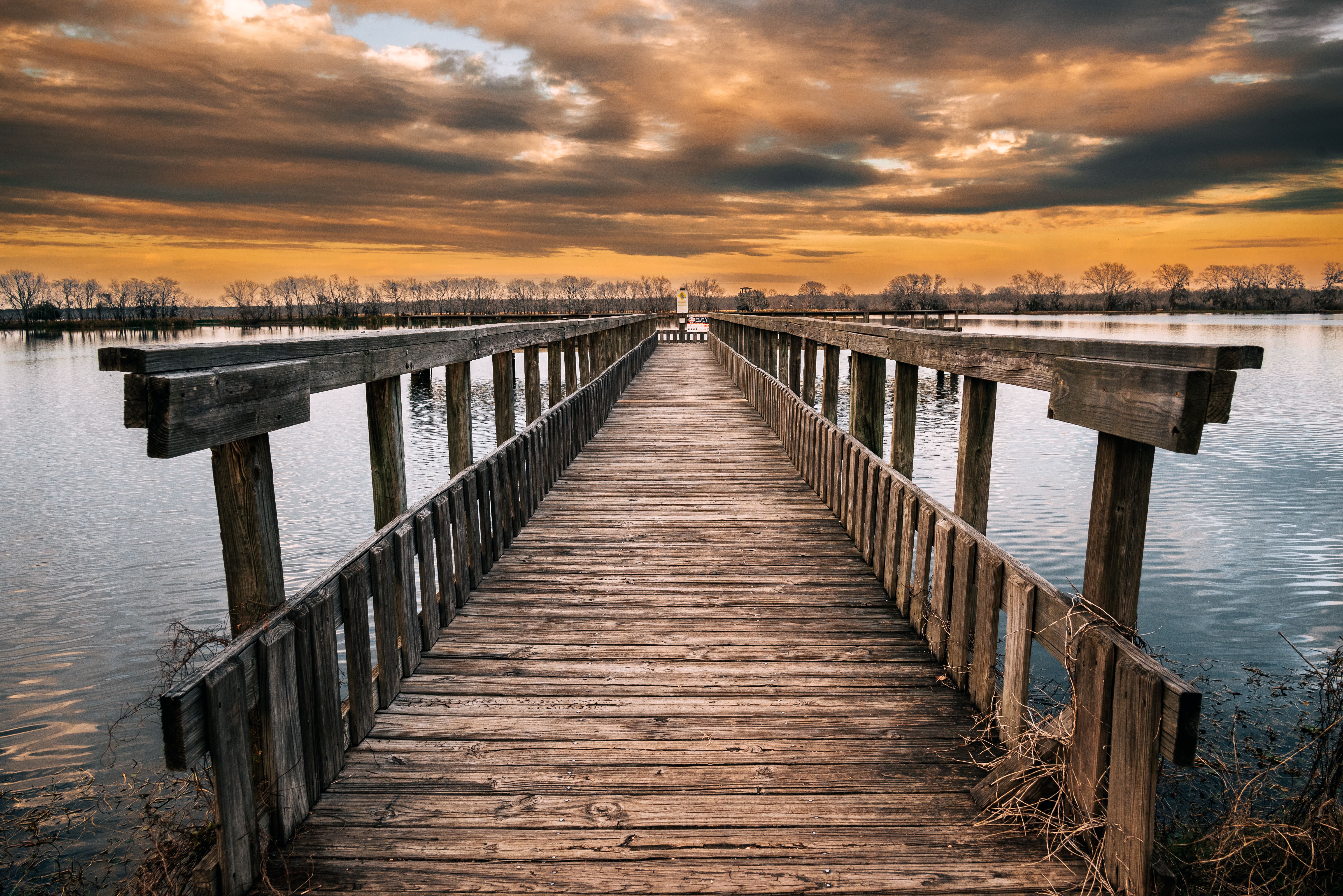 Brown Wooden Dock on Body of Water During Sunset · Free Stock Photo