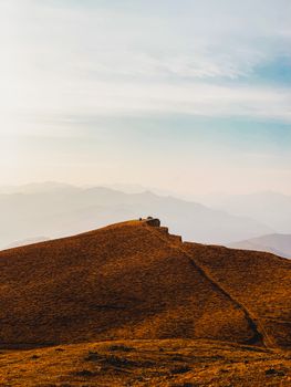 Embrace the serene beauty of Gunib's rolling hills and distant mountains in Dagestan, Russia.