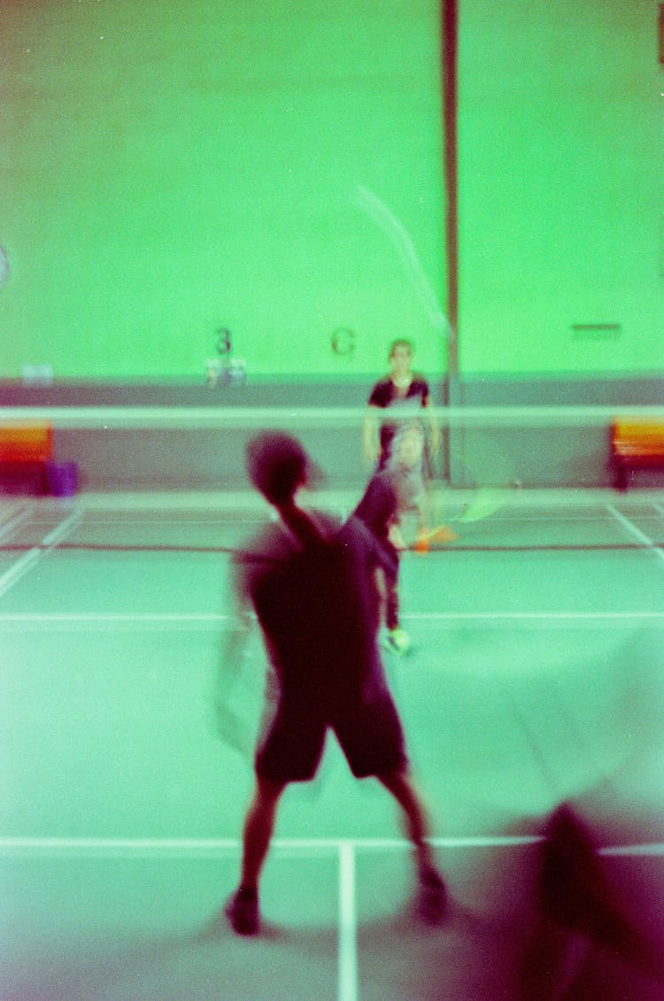 Two People Playing Badminton