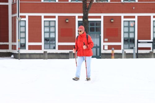 Free Woman walking with Nordic poles in snowy Jönköping, Sweden, winter time Stock Photo