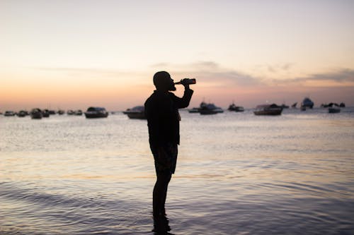 Silhouette Photo Of Man Drinking 