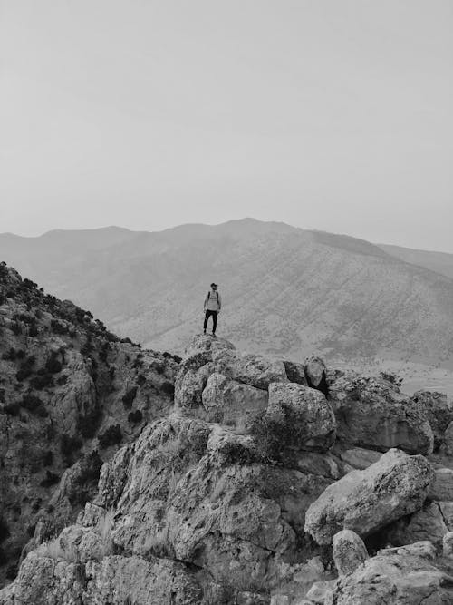 Person Standing on Rock Formation