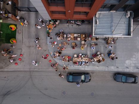 Top-down view of an outdoor cafe in Novosibirsk with people enjoying casual dining.