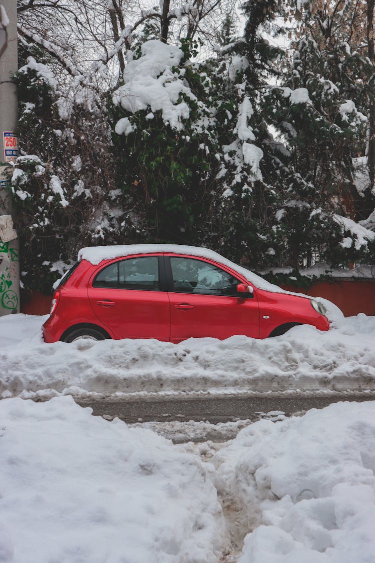 Red Car Covered With Snow