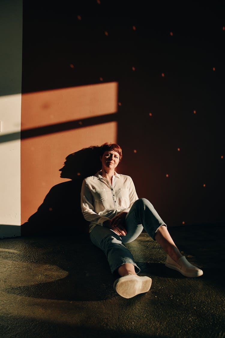 Woman In White Jacket Sitting On Floor