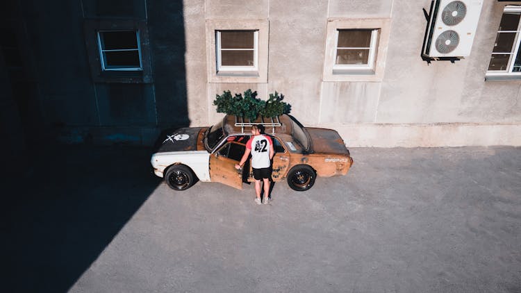 Man Entering A Rusty Car