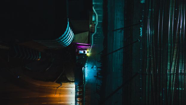 Dramatic aerial night view of a street and railway in Novosibirsk, Russia, with vivid street lights.