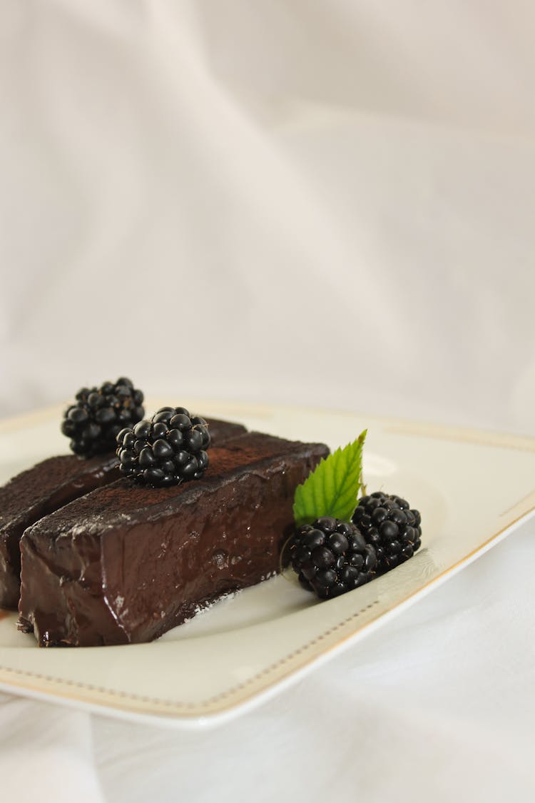 Chocolate Cake With Raspberry On White Ceramic Plate