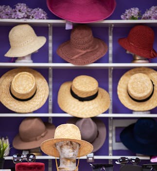 A stylish assortment of summer hats on shelves, featured in a fashionable store display.