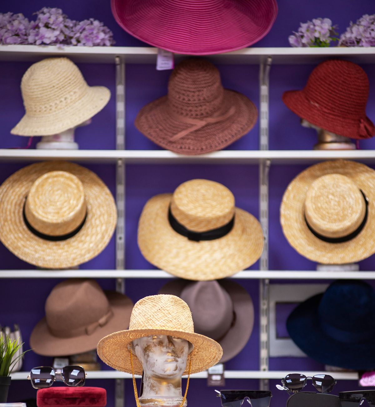 Different styles of sun hats displayed in a shop