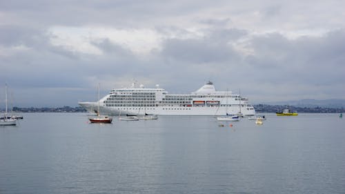 White Cruise Ship on Sea Under White Clouds