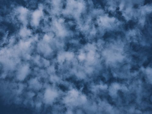 Free A striking image of blue sky covered with fluffy white clouds, forming unique patterns. Stock Photo