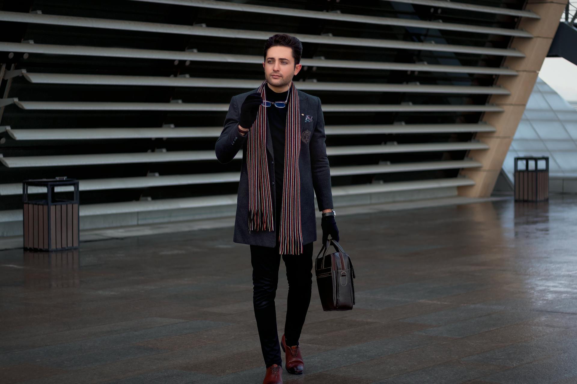 A Man with Scarf Holding a Briefcase