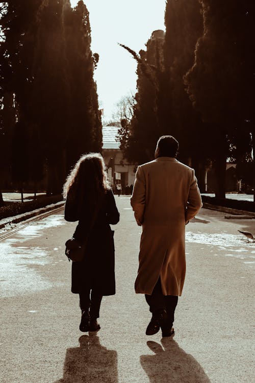 Back View of a Man and Woman Walking Togetheer