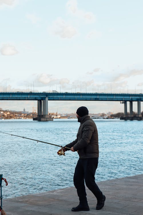 A Man Fishing Near the River