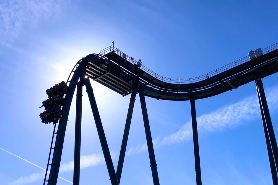 Exciting roller coaster ride at theme park in Soltau, Germany on a sunny day.