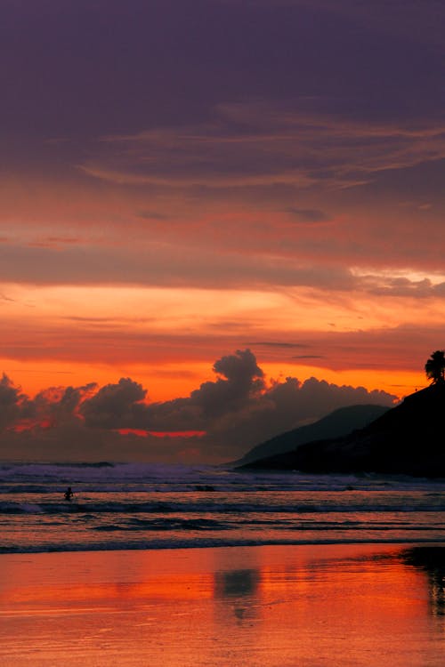 Silhouette of Person in the Sea During Sunset