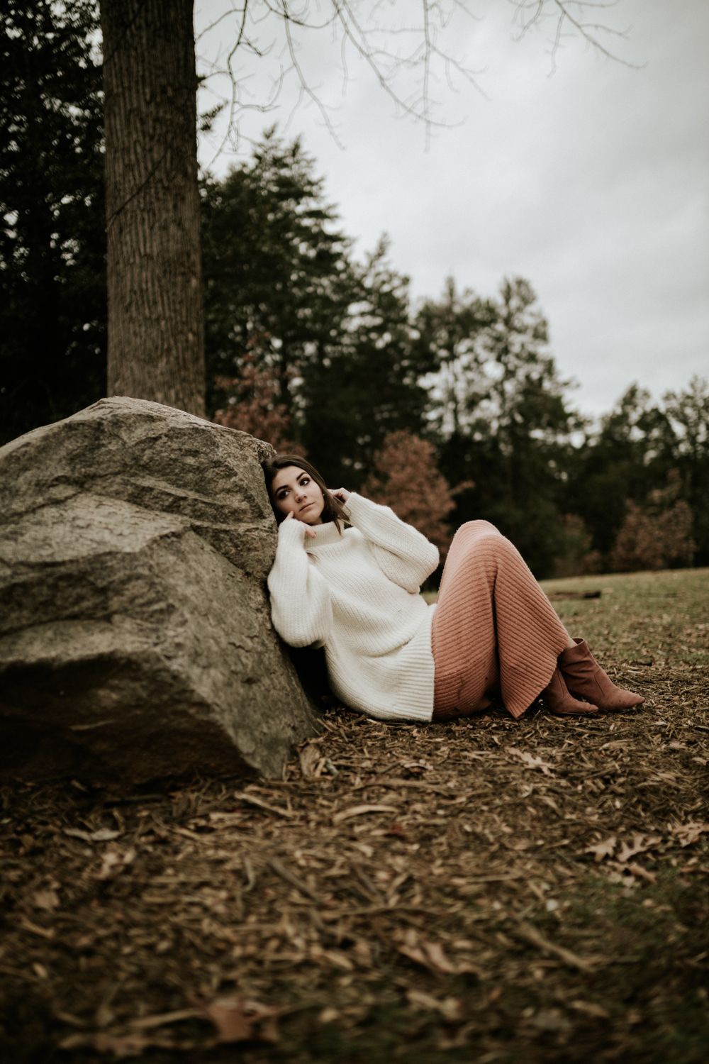 Woman in Sweater Sitting on Leaves · Free Stock Photo