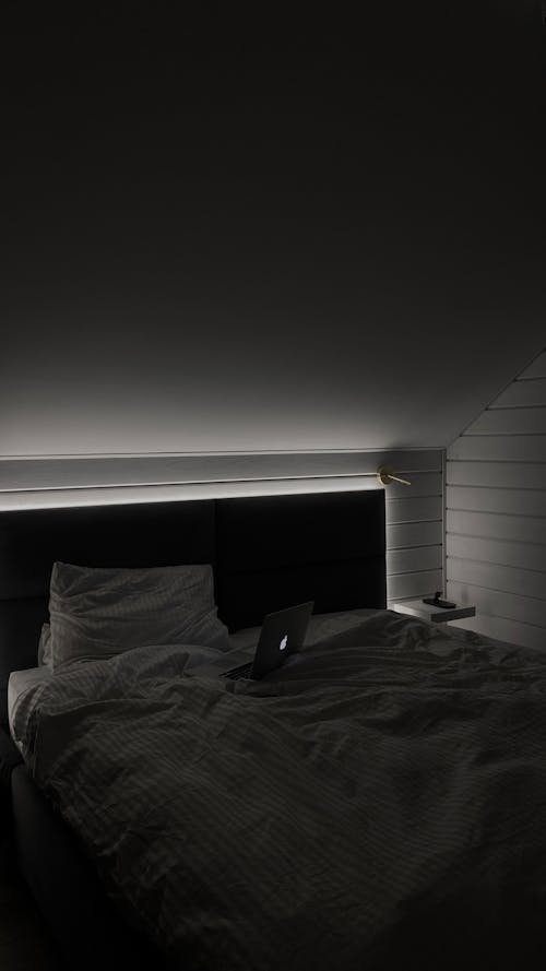 A Laptop Computer on Dark Bedroom