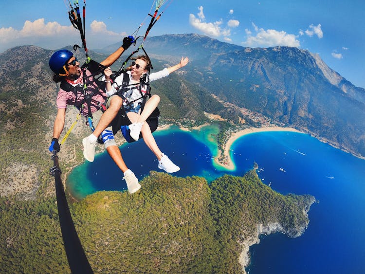 Man And Woman Paragliding