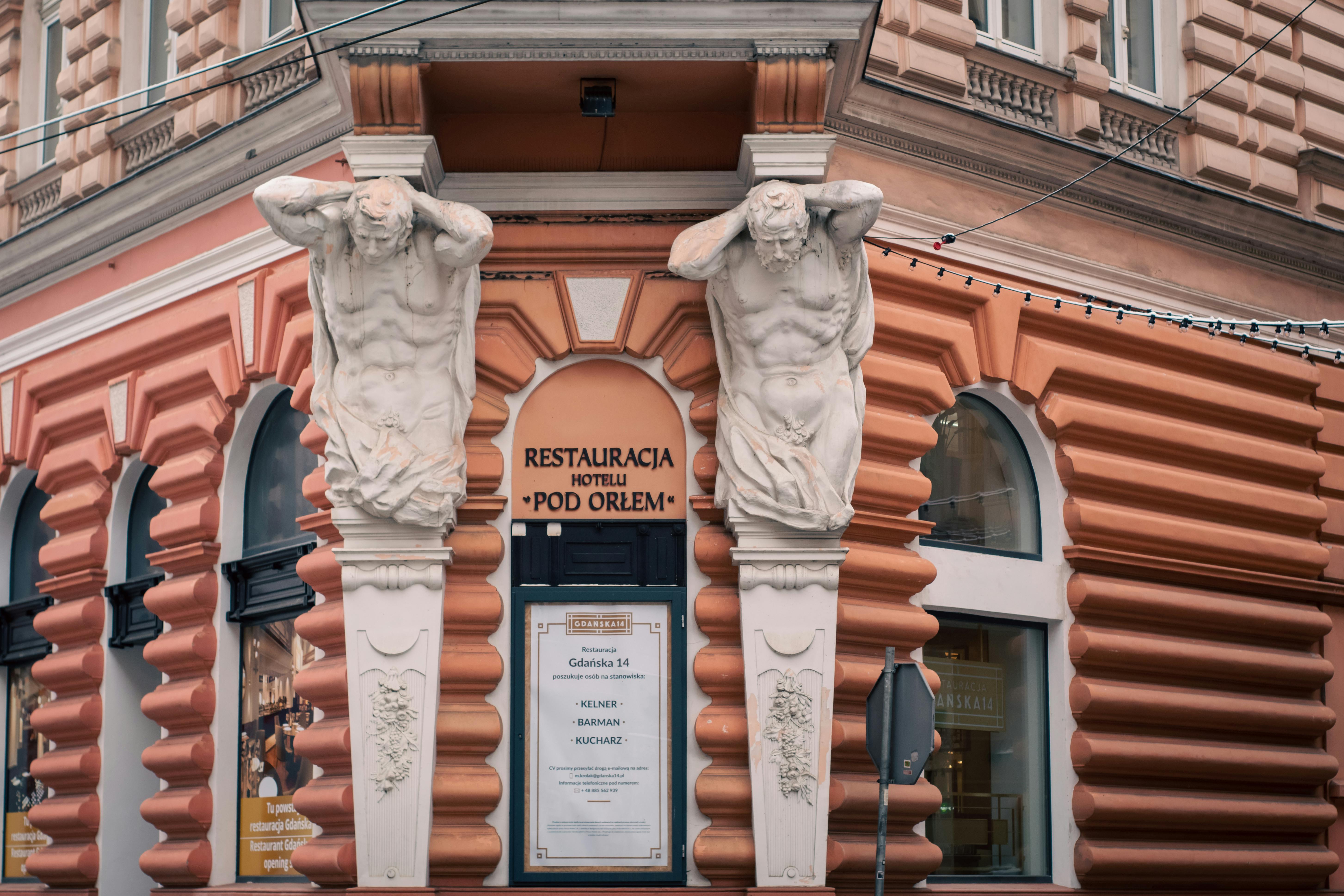 Free Historic corner of Hotel Pod Orłem in Bydgoszcz, featuring decorative sculptures. Stock Photo