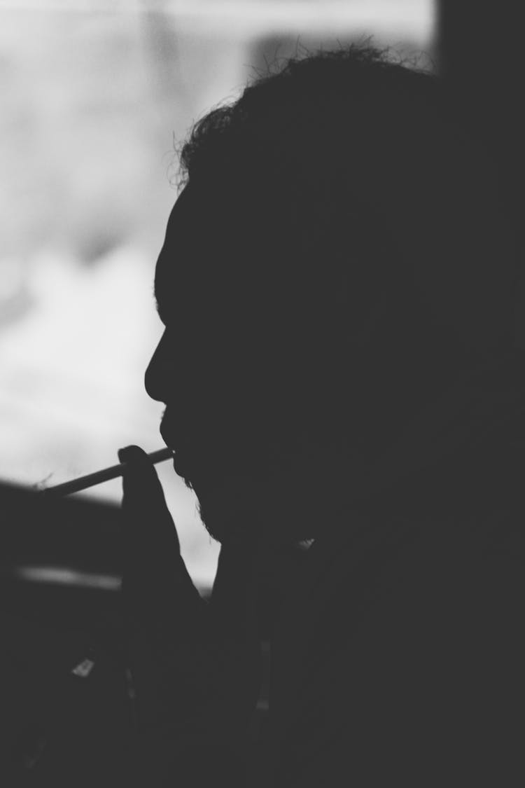 Silhouette Of A Person Smoking Cigarette