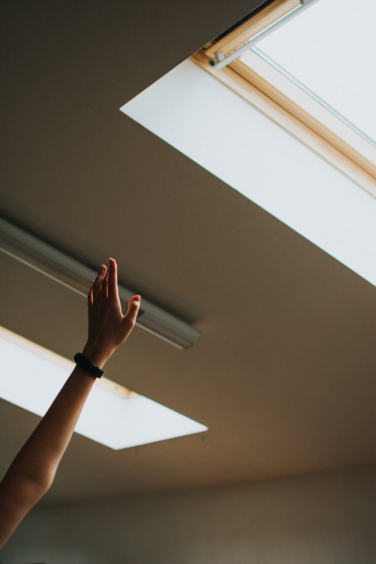 Arm Stretching Towards Roof Window