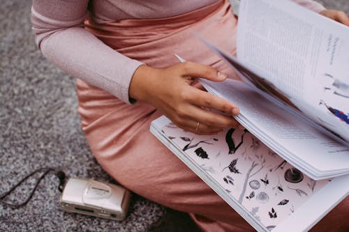 Free Close Up of Woman Holding Open Book Stock Photo