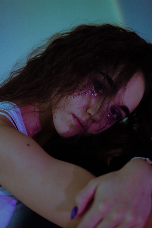 Free Captivating moody portrait of a woman with glitter makeup, conveying emotion and depth. Stock Photo