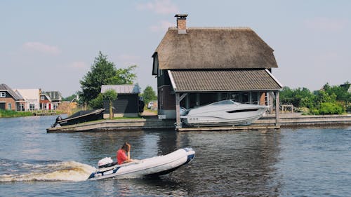 Person on White Inflatable Speed Boat