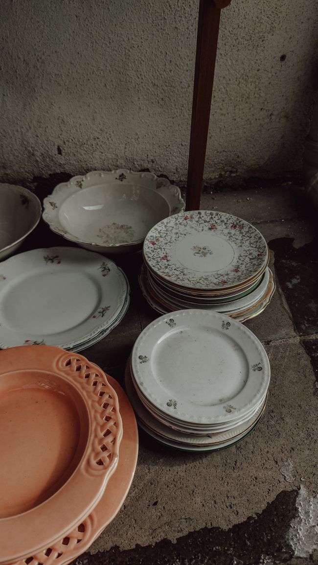 Stacks of vintage floral china on a shelf, photo by Nur on Pexels