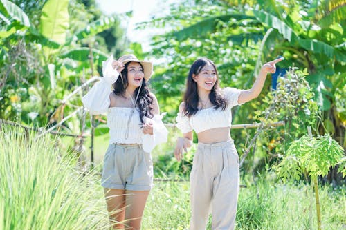 Women Standing on Green Grass Field