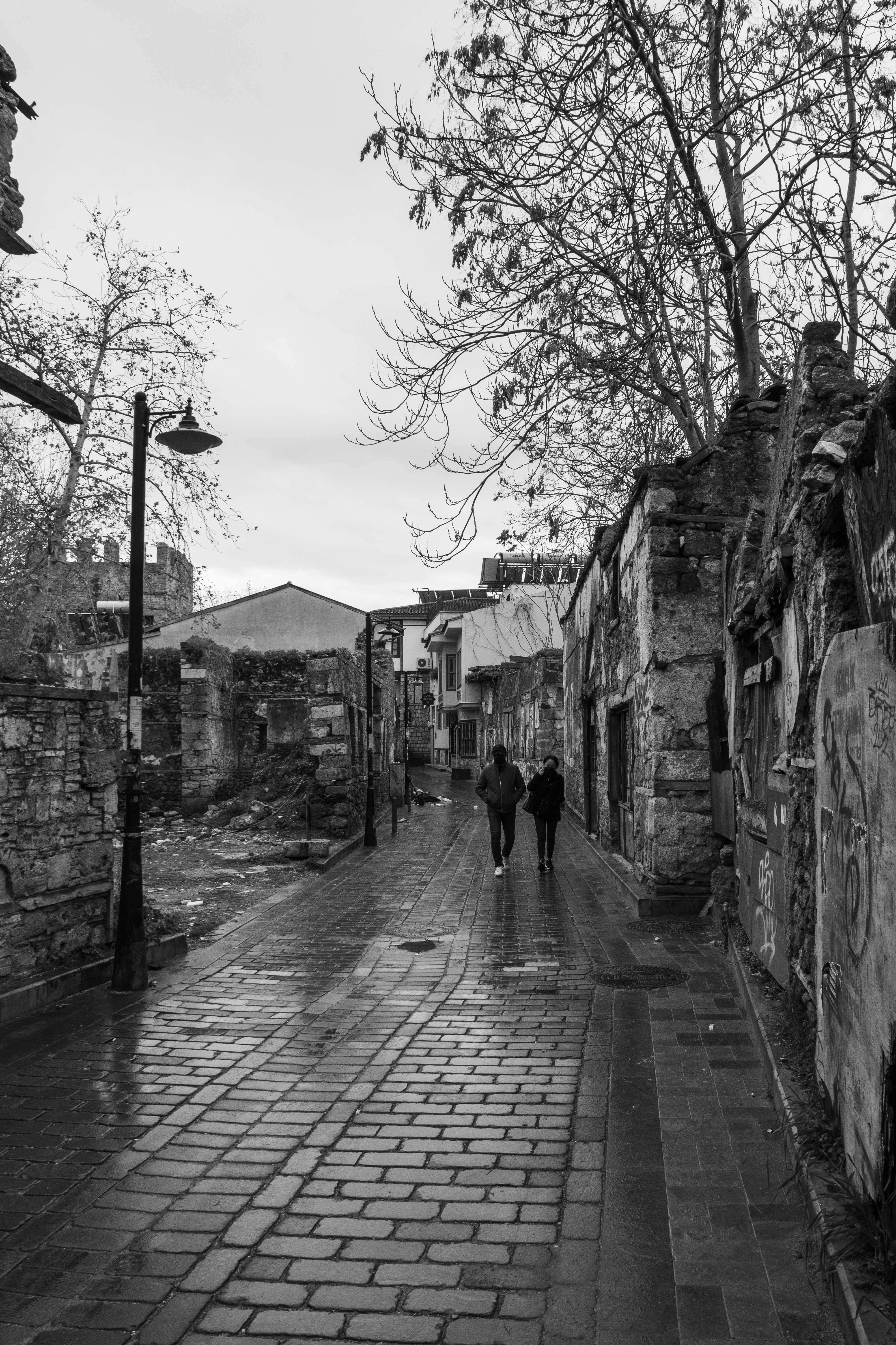 Grayscale Photo of Two People Walking on the Sidewalk · Free Stock Photo