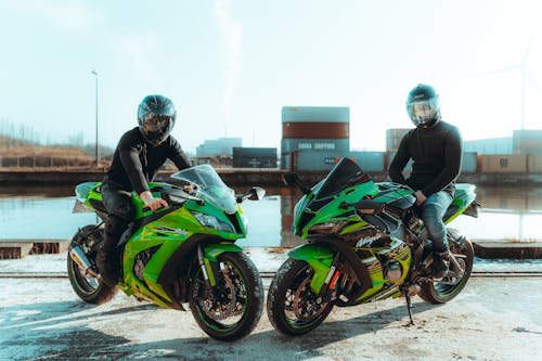 Men in Black Long Sleeves Riding Green and Black Motorcycle