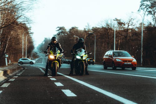 Men Riding Motorcycle on Road